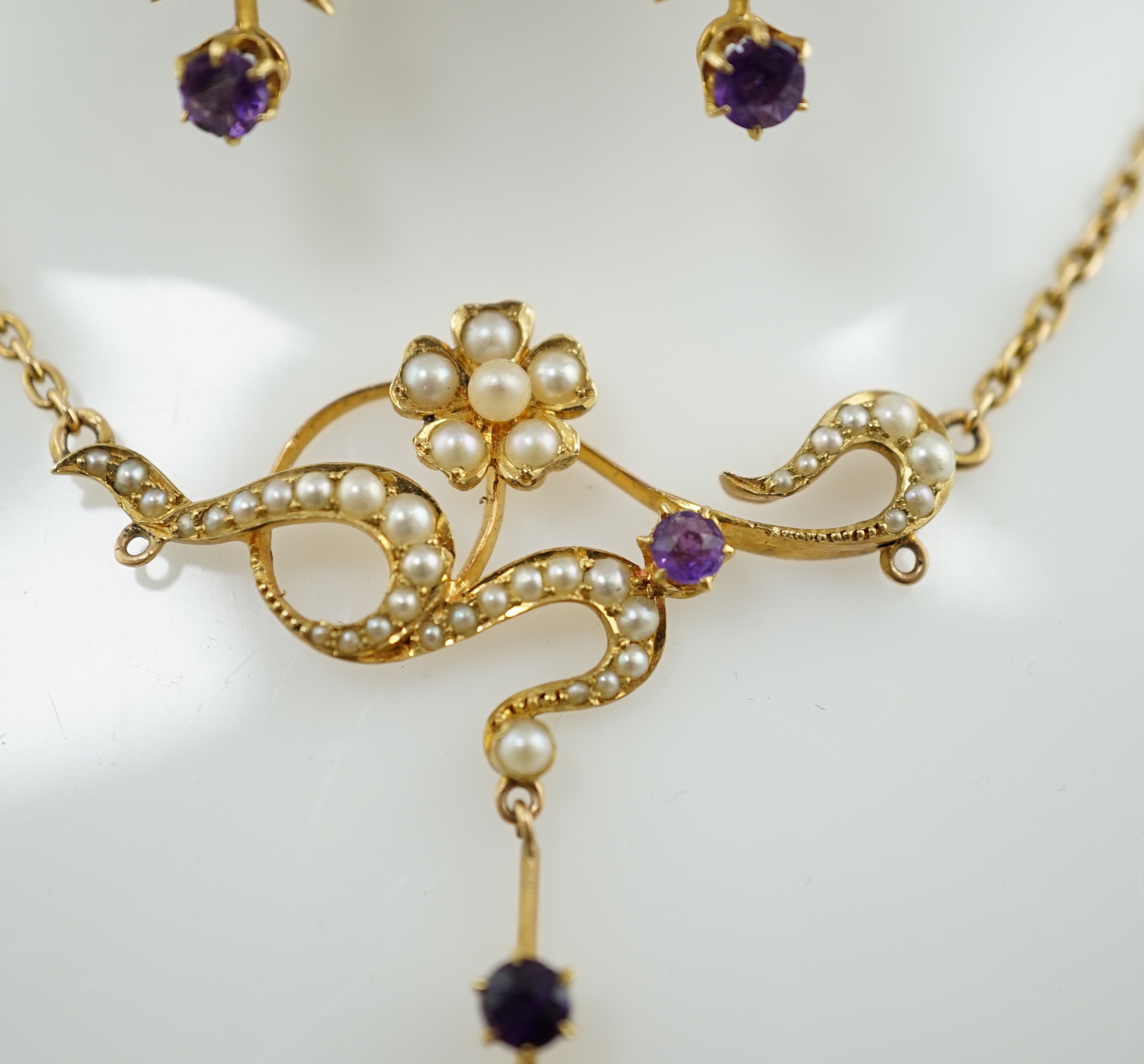 An Edwardian 15ct gold, seed pearl and amethyst set drop necklace and a pair of matching unmarked earrings